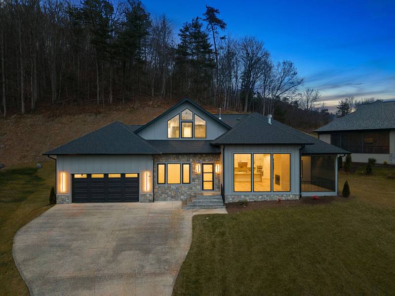 A completed Big Hills Construction home in Western North Carolina at dusk, showing the roofline and framing details the new state building code is designed to strengthen